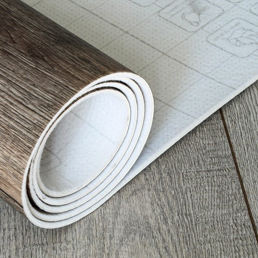 Roll of linoleum with a wood texture. Types of floor coverings. PVC.