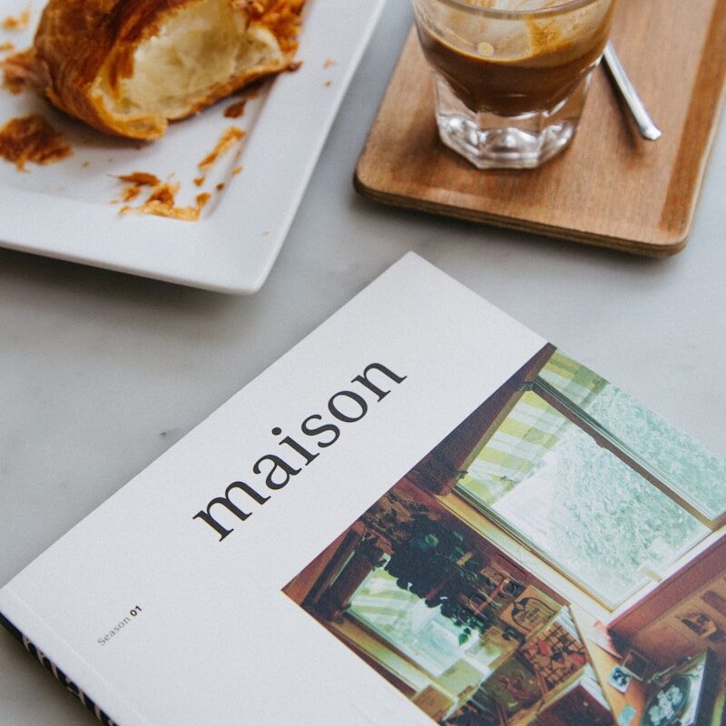 white and brown ceramic plate with bread on brown wooden tray